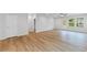 Open-concept living room features wood floors, neutral paint, a ceiling fan and lots of light at 401 Village Ln, Fairburn, GA 30213