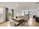 Open concept living space with dining area, fireplace and comfortable seating perfect for entertaining at 401 Village Ln, Fairburn, GA 30213