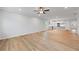 Open living space with wood floors, recessed lights, neutral paint and kitchen in background at 401 Village Ln, Fairburn, GA 30213