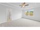Spacious main bedroom boasts tray ceilings, soft carpet, and view of outside at 401 Village Ln, Fairburn, GA 30213