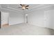 Bright primary bedroom with tray ceilings, carpet, and ensuite bathroom access at 401 Village Ln, Fairburn, GA 30213