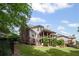 Spacious backyard with a wrought iron fence, grassy lawn, and multi-level deck feature at 5025 Savannah Run, Cumming, GA 30040
