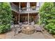 Inviting backyard patio with stone fire pit and ample seating, perfect for outdoor entertaining at 5025 Savannah Run, Cumming, GA 30040