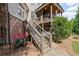 Backyard staircase leads to a covered patio, offering seamless indoor-outdoor living at 5025 Savannah Run, Cumming, GA 30040