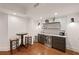 The basement features a stylish wet bar, perfect for entertaining and conveniently equipped with modern appliances at 5025 Savannah Run, Cumming, GA 30040