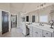 Bathroom features a double vanity with white cabinets and bright lighting fixtures at 5025 Savannah Run, Cumming, GA 30040