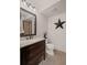 Well-lit bathroom with granite counters, dark wood vanity, decorative star and tiled floors at 5025 Savannah Run, Cumming, GA 30040