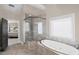 Spacious bathroom with a walk-in shower, soaking tub and neutral tile at 5025 Savannah Run, Cumming, GA 30040