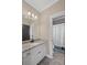 Bathroom featuring granite counters, white cabinets, tile floor and modern fixtures at 5025 Savannah Run, Cumming, GA 30040