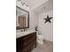 Bathroom featuring a wood vanity with granite countertops, wood floors, and a tiled shower at 5025 Savannah Run, Cumming, GA 30040