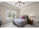 Comfortable bedroom with soft carpet, ceiling fan, and a serene atmosphere at 5025 Savannah Run, Cumming, GA 30040