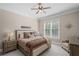 Cozy bedroom featuring a ceiling fan, window with blinds, and warm, neutral tones at 5025 Savannah Run, Cumming, GA 30040