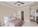 Bedroom with a ceiling fan, carpet, ensuite bathroom, and neutral color scheme at 5025 Savannah Run, Cumming, GA 30040