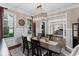 Elegant dining room featuring a decorative chandelier, wainscoting, and large windows at 5025 Savannah Run, Cumming, GA 30040