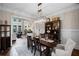 Dining room with a dark wood table, decorative chandelier, and wainscoting at 5025 Savannah Run, Cumming, GA 30040
