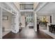 Spacious foyer featuring dark hardwood floors, an open staircase, and views into multiple living areas at 5025 Savannah Run, Cumming, GA 30040