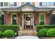 Close-up of the front door with a stone entryway, dark wood columns, and a wreath at 5025 Savannah Run, Cumming, GA 30040