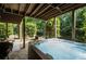 Backyard patio showcasing a hot tub, an outdoor seating area and mature trees at 5025 Savannah Run, Cumming, GA 30040