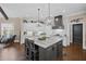 Modern kitchen featuring a large island with marble countertops, stainless steel appliances, and custom cabinetry at 5025 Savannah Run, Cumming, GA 30040