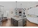 Open concept kitchen with large island, stainless steel appliances, and a view of the fireplace at 5025 Savannah Run, Cumming, GA 30040