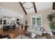 Open-concept living area with hardwood floors and a view of the kitchen and staircase at 5025 Savannah Run, Cumming, GA 30040
