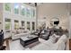 Spacious living room with a fireplace, large windows, and neutral furniture at 5025 Savannah Run, Cumming, GA 30040