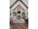Spacious living room featuring vaulted ceiling with wooden beams, stone fireplace, and large windows at 5025 Savannah Run, Cumming, GA 30040
