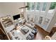Spacious living room with a fireplace, large windows, and comfortable seating arrangement at 5025 Savannah Run, Cumming, GA 30040