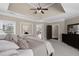 Bright main bedroom features a tray ceiling, neutral paint, and doorway leading to the rest of the house at 5025 Savannah Run, Cumming, GA 30040