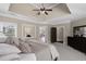 Tranquil main bedroom with a tray ceiling, recessed lighting and neutral decor at 5025 Savannah Run, Cumming, GA 30040