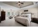 Spacious main bedroom featuring a tray ceiling, sitting area, and luxurious decor at 5025 Savannah Run, Cumming, GA 30040