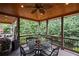 Enjoy the outdoors on this covered porch with dining and picturesque nature views at 5025 Savannah Run, Cumming, GA 30040