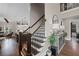 Elegant staircase with dark wood and iron railings, showcasing the home's open floor plan at 5025 Savannah Run, Cumming, GA 30040