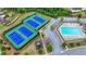 Aerial view showcasing community tennis courts, a swimming pool, and manicured green spaces at 1147 Halletts Peak Pl, Lawrenceville, GA 30044