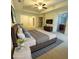 Well-lit primary bedroom featuring tray ceilings and en-suite bathroom access at 1147 Halletts Peak Pl, Lawrenceville, GA 30044