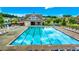 A beautiful community swimming pool awaits with plenty of chairs and umbrellas at 1147 Halletts Peak Pl, Lawrenceville, GA 30044
