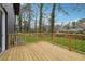 Wooden back deck overlooking a lush green backyard and mature trees, with a black brick home exterior at 1667 Atherton Cir, Decatur, GA 30035