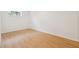 Bright bedroom featuring hardwood floors, white trim and walls, and a single window for natural light at 1667 Atherton Cir, Decatur, GA 30035