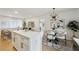 Modern kitchen and dining area with bright lighting, white cabinetry, and stylish decor at 1667 Atherton Cir, Decatur, GA 30035