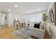 Bright living room with light wood floors, a comfortable sofa, and modern artwork on the walls at 1667 Atherton Cir, Decatur, GA 30035