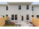 Rear exterior view of home featuring fenced yard, patio, and seating area at 316 Navigator Ln, Mcdonough, GA 30253