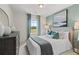 Serene bedroom featuring calming colors, stylish decor, and a window with a pleasant outdoor view at 316 Navigator Ln, Mcdonough, GA 30253