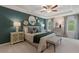 Spacious main bedroom featuring a trey ceiling, fan, and accent wall at 316 Navigator Ln, Mcdonough, GA 30253