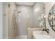 This bathroom shower features light tile, a rain shower head, and sleek glass enclosure at 392 Concord St, Alpharetta, GA 30009
