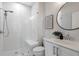 Modern bathroom includes a glass-enclosed shower with white subway tile and a sleek vanity with round mirror at 392 Concord St, Alpharetta, GA 30009