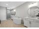 This bathroom features a modern tub, double sinks, white cabinets, and a glass shower at 392 Concord St, Alpharetta, GA 30009
