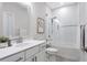 Bright bathroom boasts subway tile, glass shower doors, and modern fixtures at 392 Concord St, Alpharetta, GA 30009