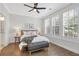 Bright bedroom featuring hardwood floors, ceiling fan, and white shutters for natural light and privacy at 392 Concord St, Alpharetta, GA 30009