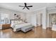 This bedroom features hardwood floors, a ceiling fan, a sitting area, and neutral-toned walls at 392 Concord St, Alpharetta, GA 30009