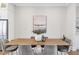 Elegant dining room showcasing a wooden table set for six, complemented by tasteful decor and natural light at 392 Concord St, Alpharetta, GA 30009